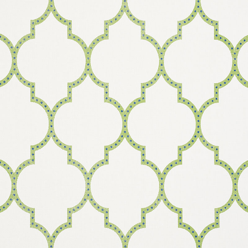 Lime-green quatrefoil lattice wallpaper on cream background with blue dot accents; repeating geometric pattern.