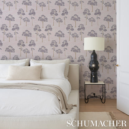 Bedroom featuring lavender tree-pattern wallpaper, white bedding, beige throw, and a dark sculptural lamp on a pale side table.