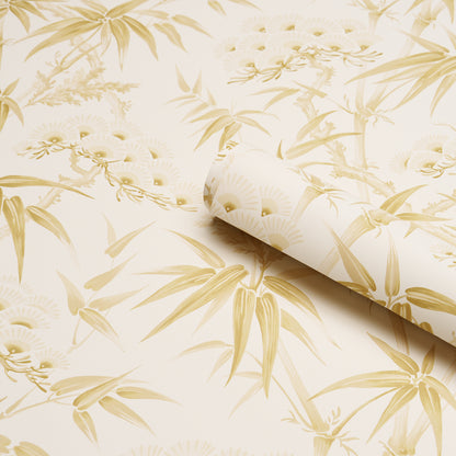 Cream wallpaper featuring gold bamboo and floral motif, rolled at the edge.