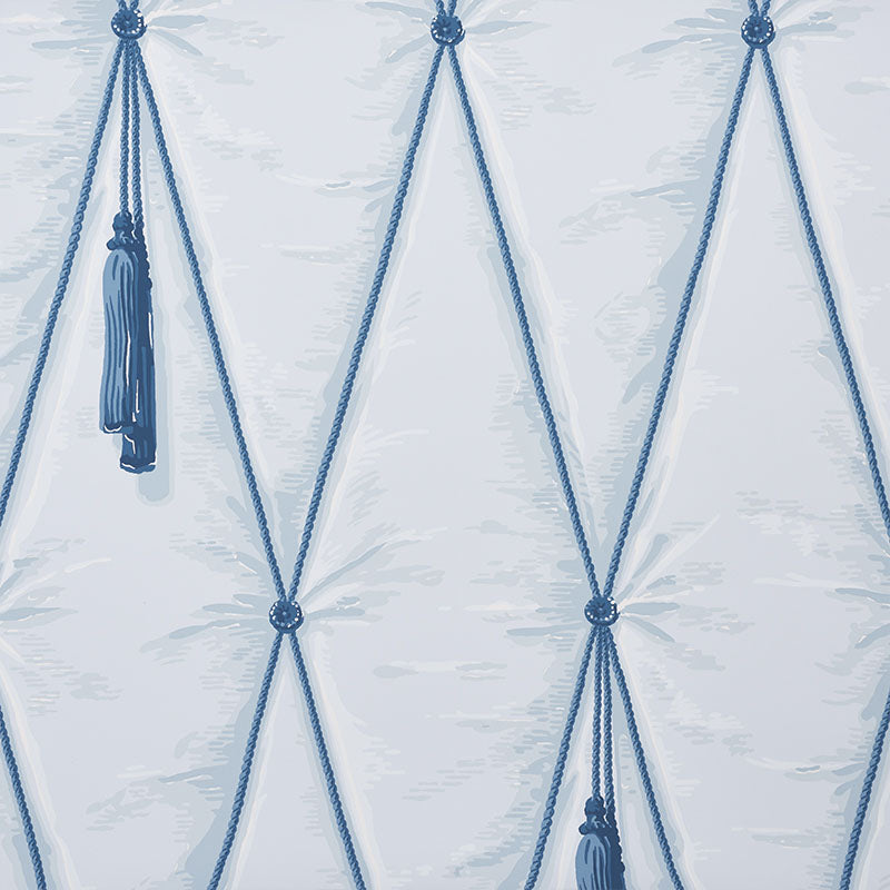 Blue cotton macrame wall hanging with diamond lattice knots and tassels.