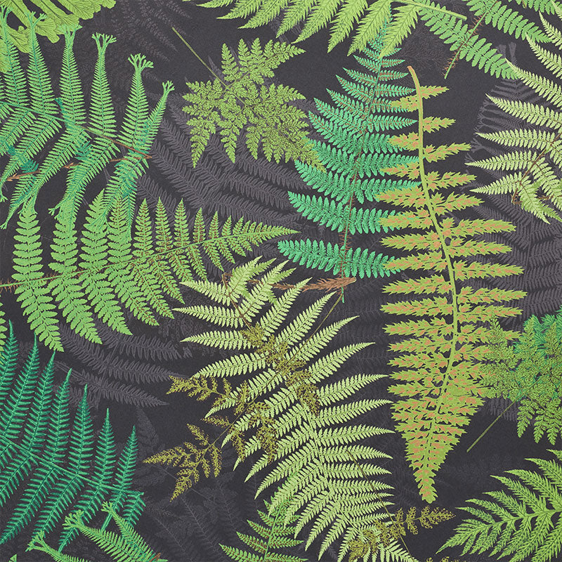 Dark fabric with layered green fern leaves; tropical botanical print for clothing or decor.