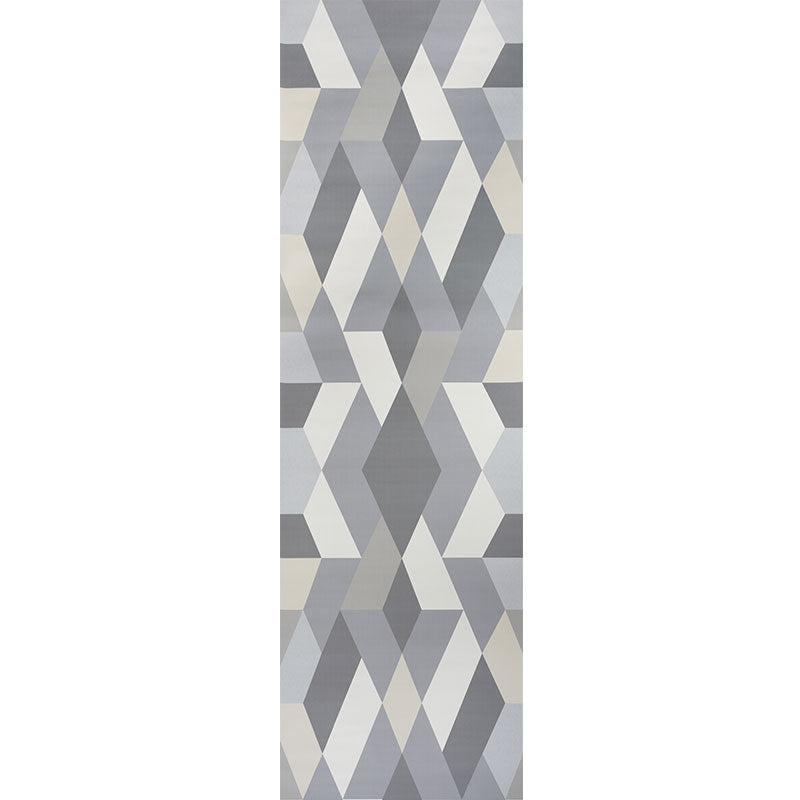Geometric rug with stacked gray, blue and beige chevron/diamond triangles in a modern abstract pattern.