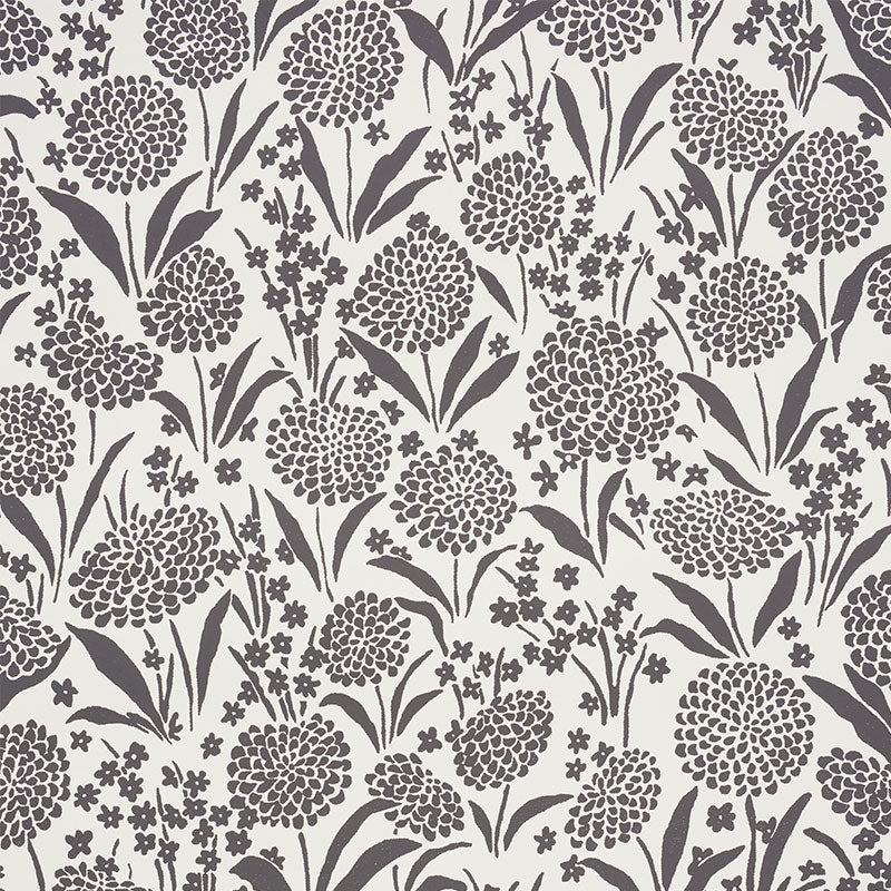 Dark purple floral pattern with round pom-pom blossoms, long leaves and tiny flowers on a cream background; a textile print.