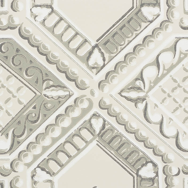 Cream-gray stone-look decorative tile pattern with a cross motif, scrollwork and scalloped borders.