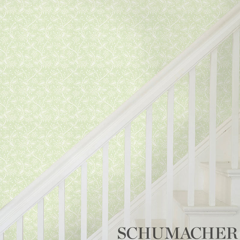 Lime-green wallpaper with a delicate white leaf pattern.