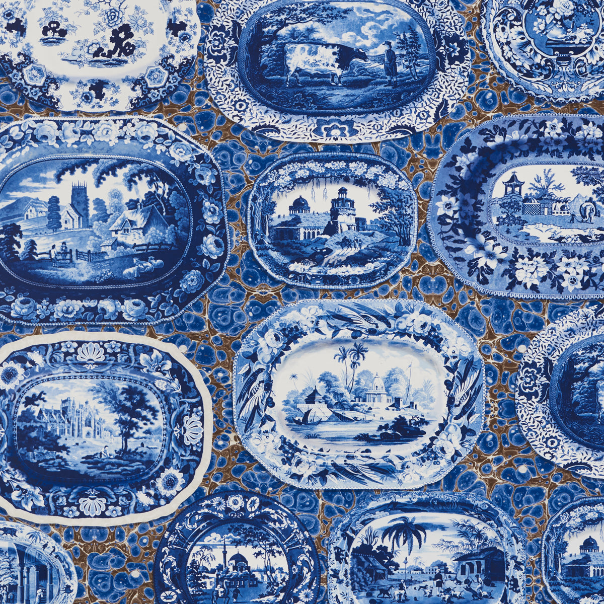 Blue and white transferware porcelain oval plates with landscape scenes, arranged together.