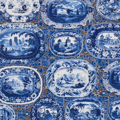 Blue and white transferware porcelain oval plates with landscape scenes, arranged together.