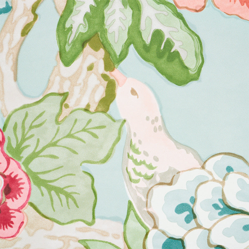 Watercolor floral pattern with green leaves and pink blooms on pale blue background; decorative fabric or wallpaper design.