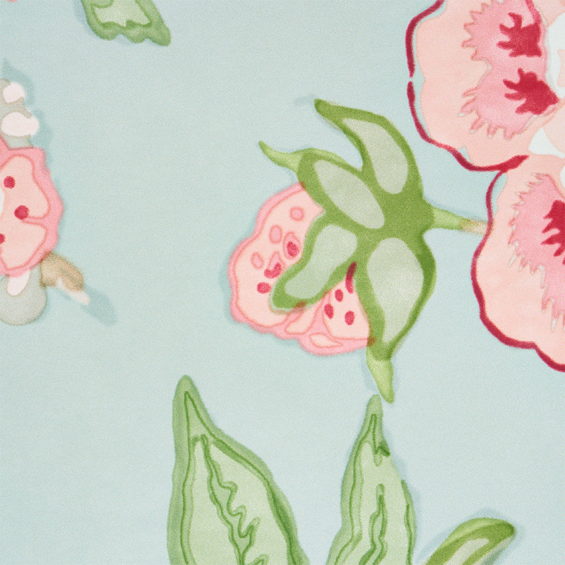 Watercolor-style floral fabric in pale blue with pink & red blossoms and green leaves