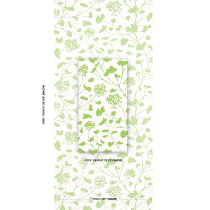 Pastel lime-green botanical wallpaper sample featuring leafy stems on ivory background, showing pattern repeat and width measurements.