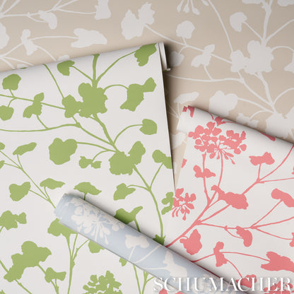 Botanical wallpaper rolls with lime green leaves and pink floral silhouettes on white.