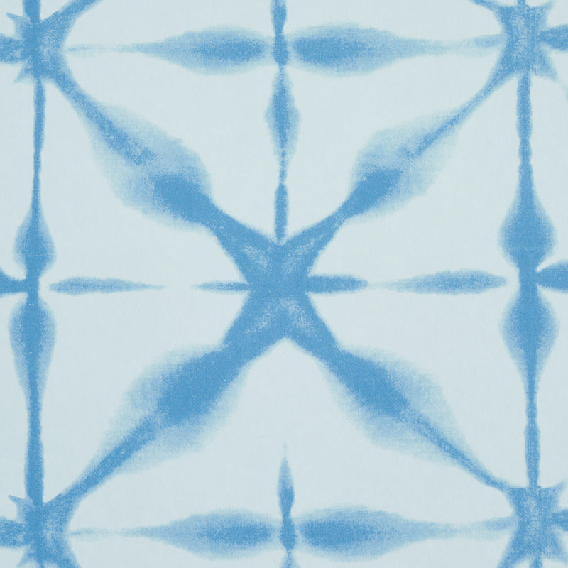 Light blue fabric with darker blue tie-dye geometric X motif, soft casual textile for apparel or home decor.
