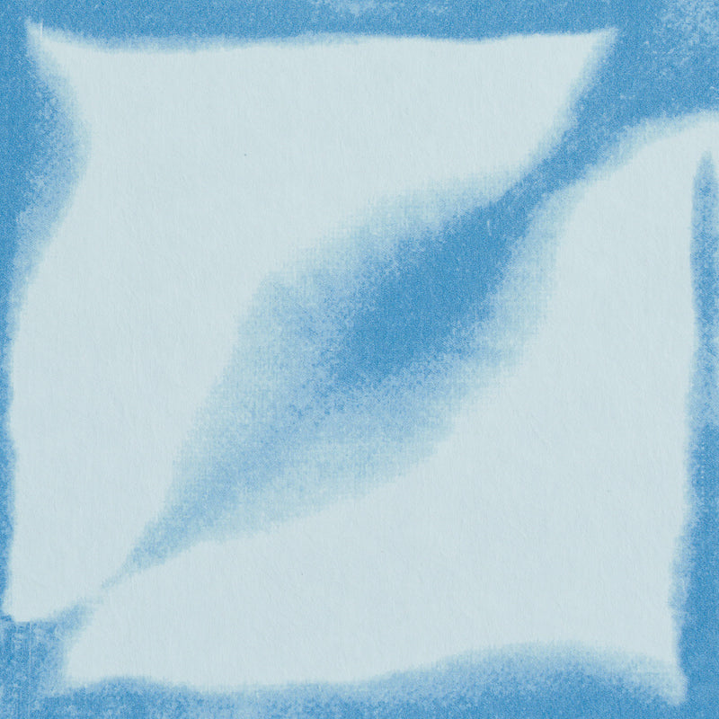 Blue watercolor brush strokes on pale blue fabric; soft textile texture with abstract decorative pattern.