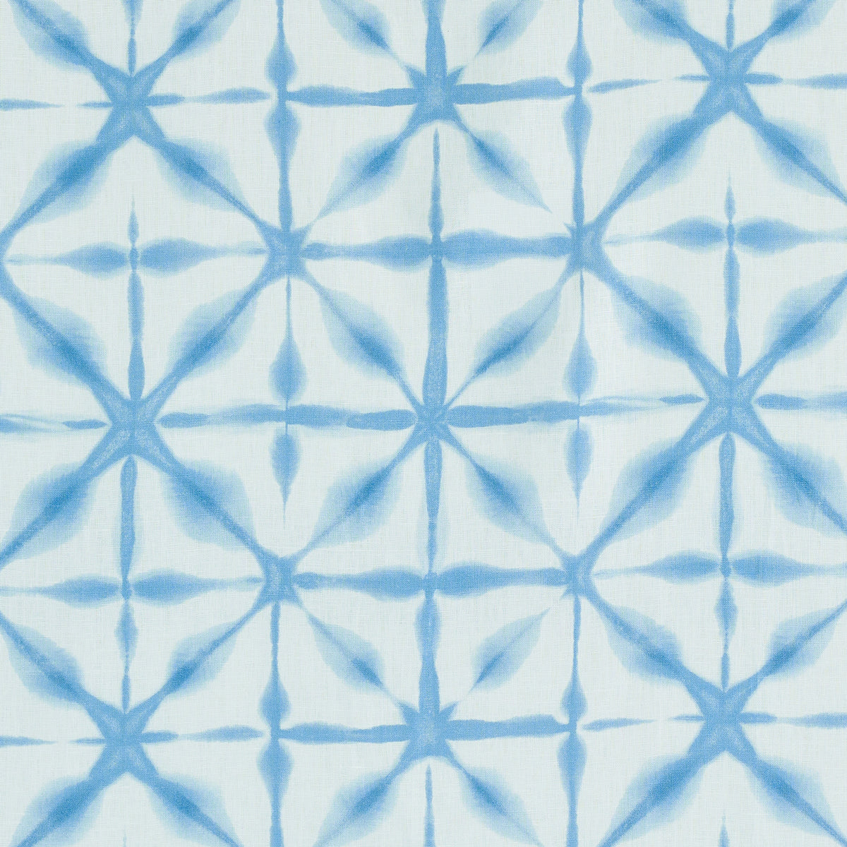 Blue tie-dye geometric lattice fabric print with starburst diamond shapes on white background.