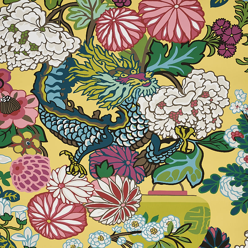 Vibrant yellow fabric with a blue dragon among pink, white, and red chrysanthemums and peonies; bold oriental floral print.