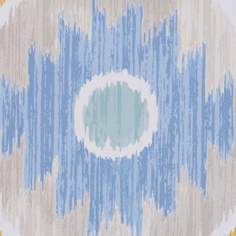 Close-up of blue Ikat pattern on beige fabric with a mint-green center circle.