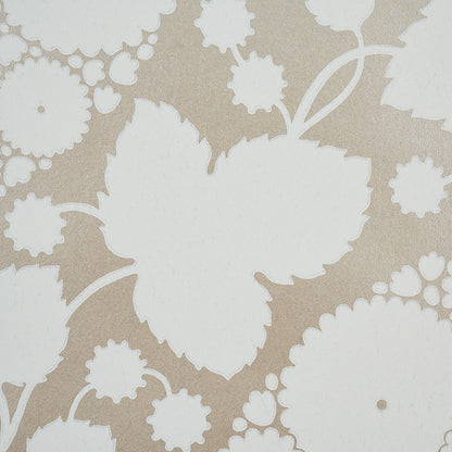 Beige wallpaper with large white leaf silhouettes and small floral motifs; retro botanical pattern.