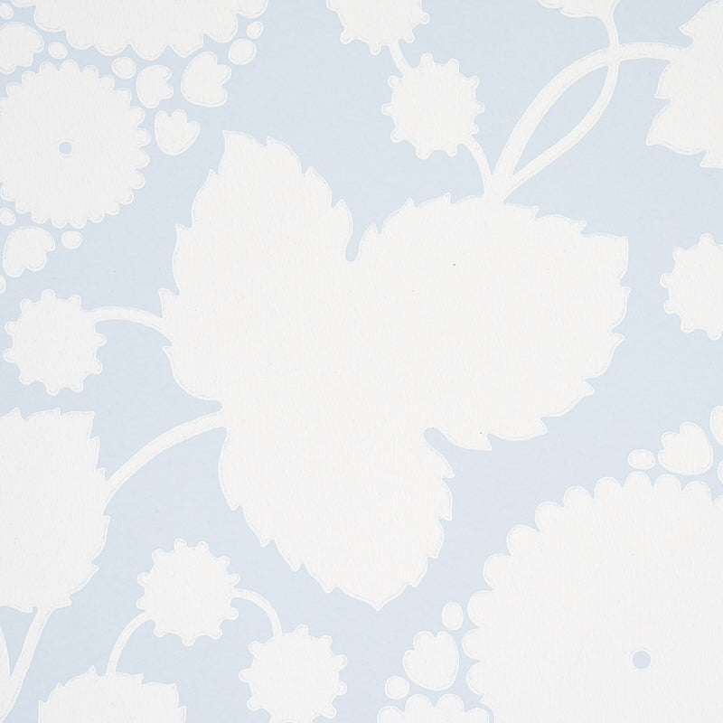 Pale blue wallpaper with large white floral silhouettes in a damask style.