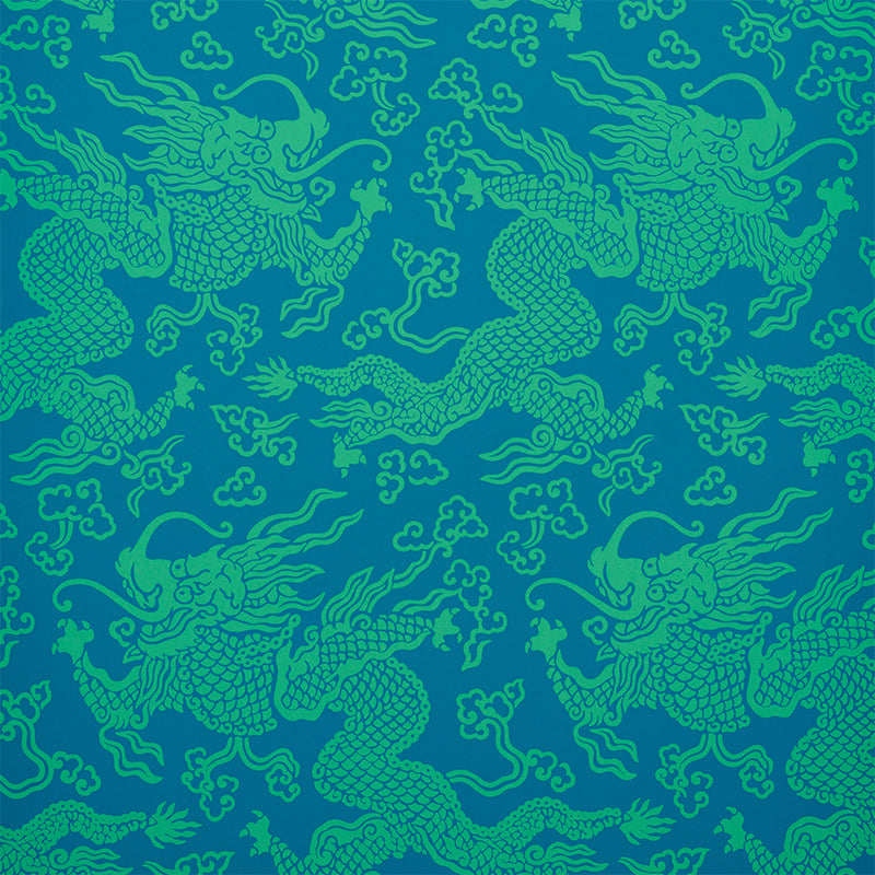 Teal dragon damask pattern on royal blue fabric; seamless decorative textile print with mythical dragon motifs.