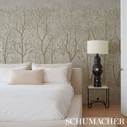 Bedroom with beige tree-pattern wallpaper, white bedding, cream pillows, and a dark ceramic lamp on a metal-frame nightstand.