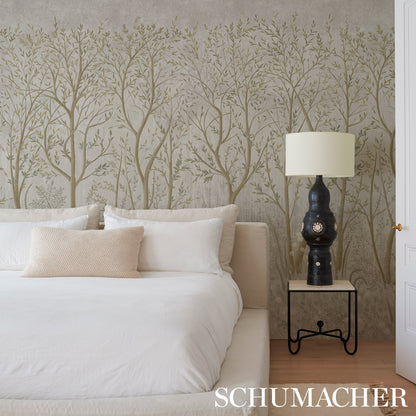 Neutral bedroom with taupe tree wallpaper, white bedding, beige cushion, black lamp with cream shade on a metal table.