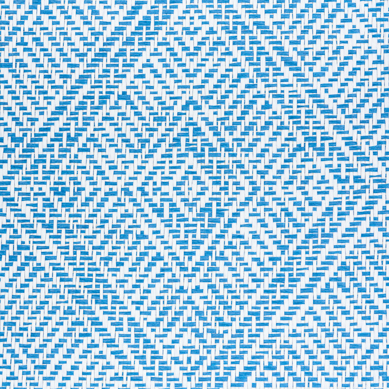 Blue and white woven wallcovering with a repeating diamond chevron pattern.