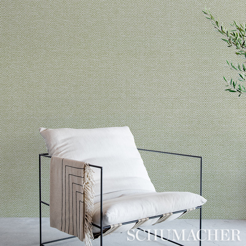 Brown woven wallpaper with a textured paperweave pattern on the wall.
