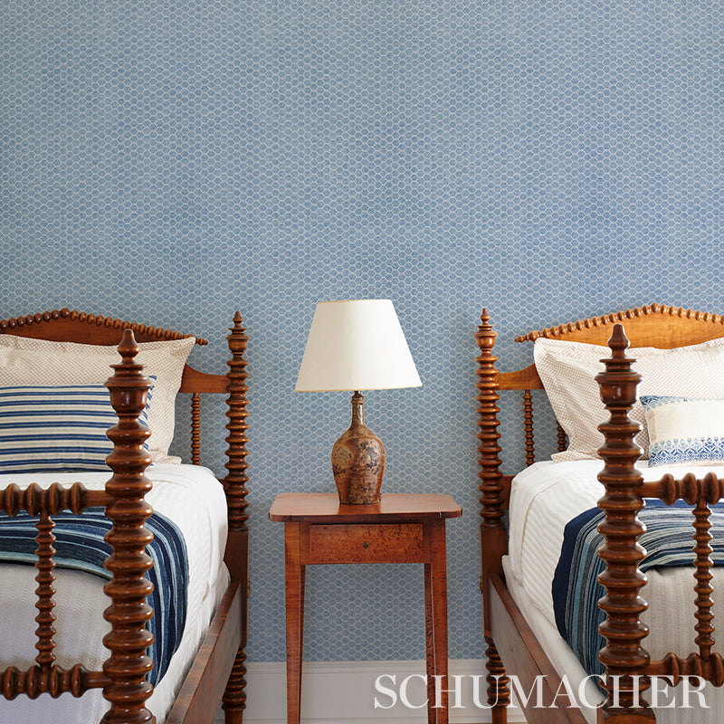Green woven wallcovering with a textured weave; close-up view.
