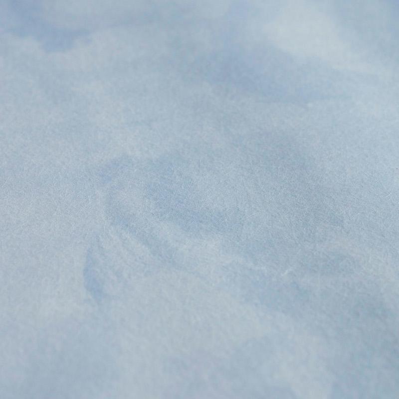 Close-up of soft light-blue fabric panel texture.