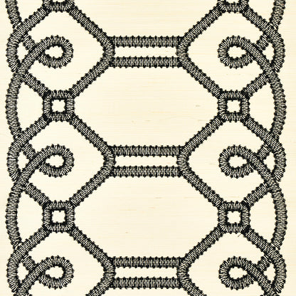 Cream fabric with black embroidered geometric lattice pattern of interlocking hexagons and scroll-like loops.