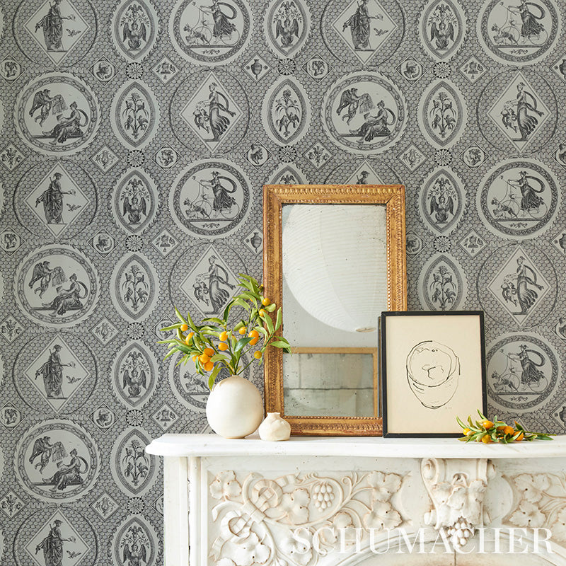 Grey damask wallpaper with white carved mantel, gold ornate mirror, black frame sketch, and white vase with orange sprigs.
