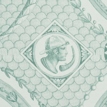 Mint-green patterned wallpaper with a fish-scale motif and a diamond frame containing a horned-creature emblem; botanical borders.