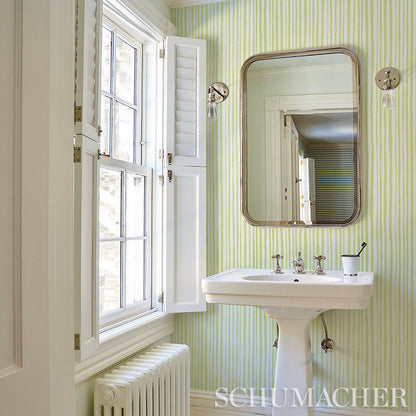 White wall covered with lime-green striped wallpaper; sketch-style stripe pattern.
