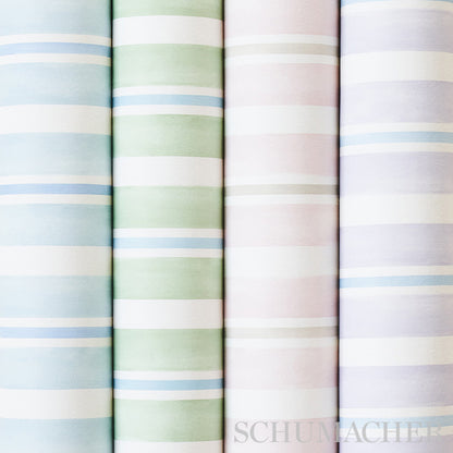 Four pastel-striped wallcovering rolls standing upright in blue, green, pink and lavender; soft cotton-like material.