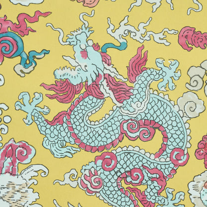 Yellow fabric featuring a blue dragon motif with pink accents, surrounded by white clouds; bold Asian-style textile.
