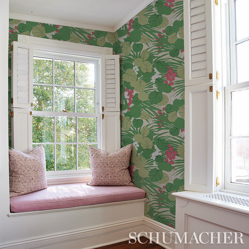 Schumacher botanical wallpaper with green leaves and pink flowers, white window seat with pink cushion and pillows.