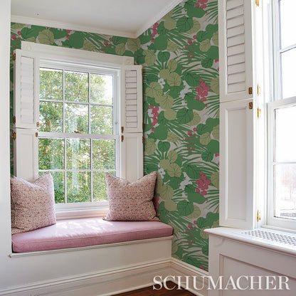 Schumacher botanical wallpaper with green leaves and pink flowers, white window seat with pink cushion and pillows.
