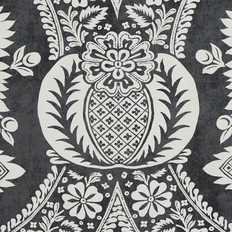 Charcoal gray and white damask textile pattern with a central pineapple-like medallion and scrolling floral motifs.