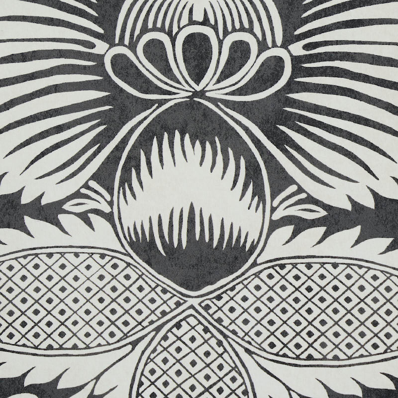 Black and white fabric with a large stylized pineapple motif and geometric lattice panels.