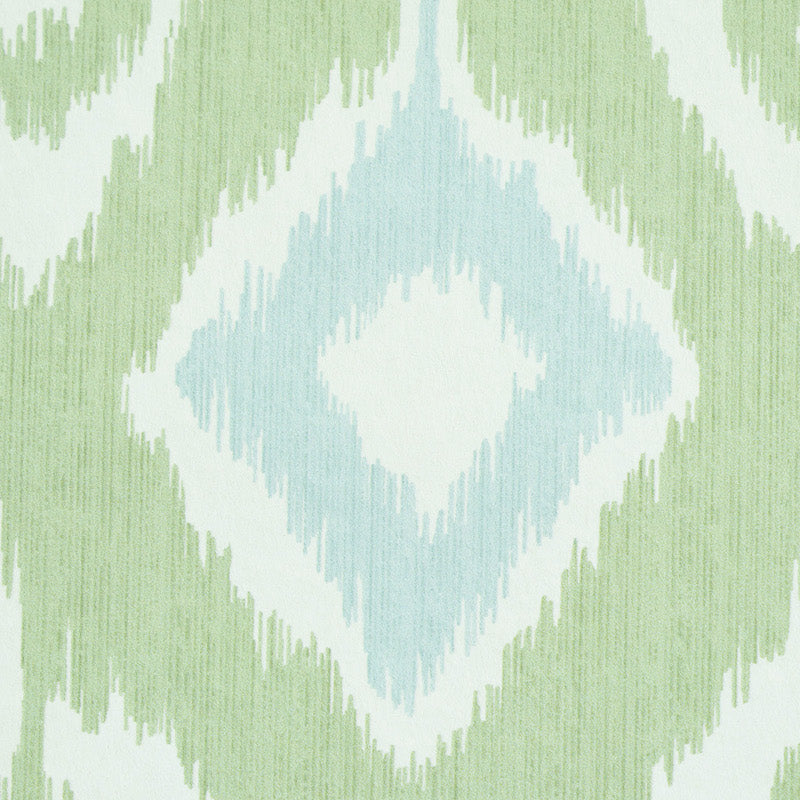 Ikat-inspired diamond pattern in mint green and pale blue on white textile.