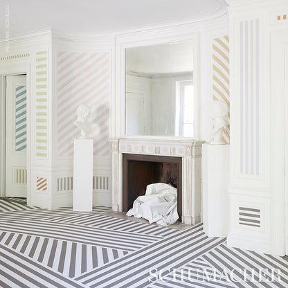 White room with pastel striped walls, ornate fireplace with large mirror, striped diagonal floor, pedestal bust.