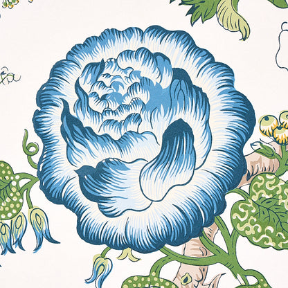 Large blue floral bloom with green vines on cream background; vintage botanical pattern.