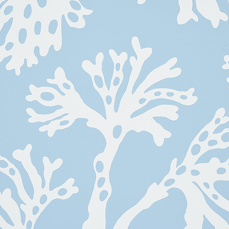 White coral-like silhouettes on a soft blue background; abstract coastal textile or wallpaper pattern.