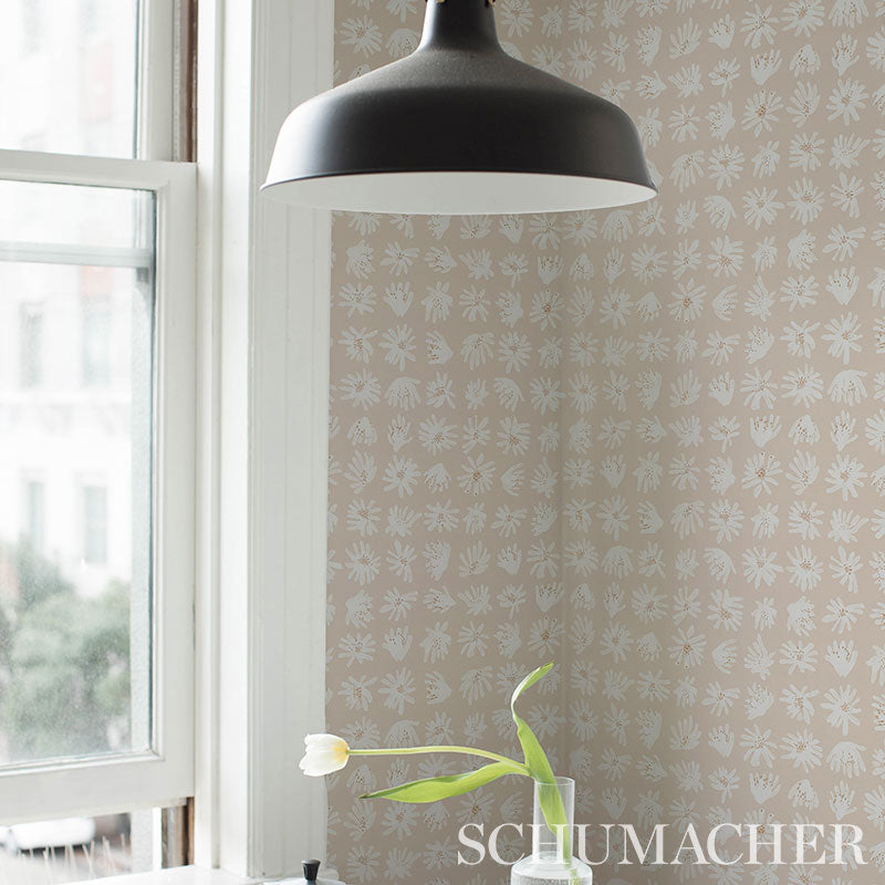 Beige wallpaper with a white botanical pattern near a window.