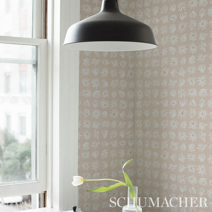 Beige wallpaper with a white botanical pattern near a window.