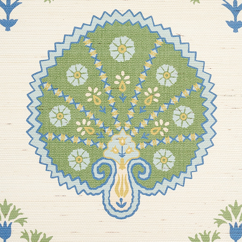 Sisal green rug with a stylized tree/peacock motif in olive green, white and yellow flowers, blue outlining and a zigzag border.