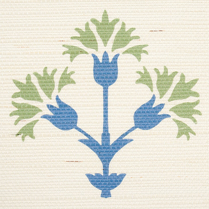 Green sisal rug with a blue three-branch floral motif and green leaves.