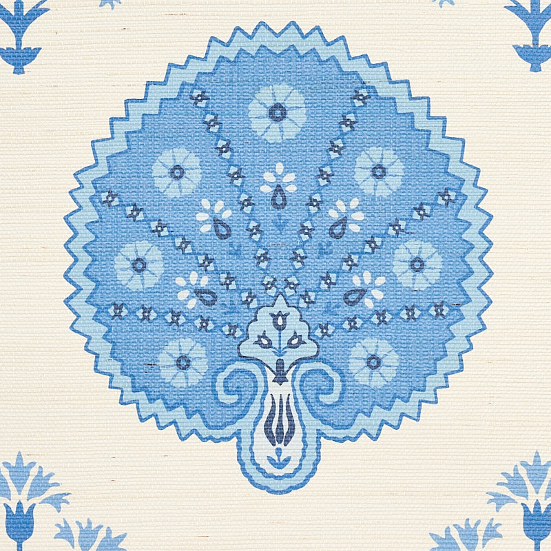 Blue circular fan-shaped mandala with floral accents on cream textile; decorative fabric print.