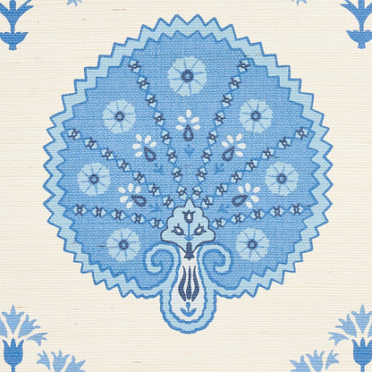 Blue circular fan-shaped mandala with floral accents on cream textile; decorative fabric print.