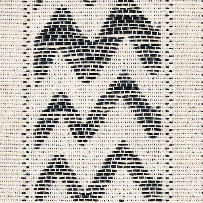 Beige woven fabric with bold black chevron zigzag pattern; textured geometric textile.
